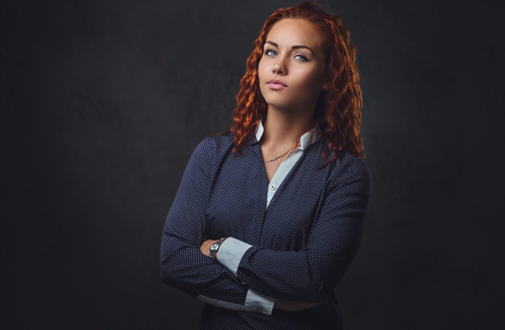 Redhead female supervisor dressed in an elegant suit.